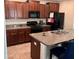Kitchen with granite countertops, stainless steel appliances, and a large kitchen island at 9616 Lemon Drop Loop, Sun City Center, FL 33573