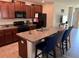Kitchen with granite countertops, stainless steel appliances, and a large kitchen island at 9616 Lemon Drop Loop, Sun City Center, FL 33573