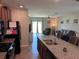 Kitchen island with granite countertops, complemented by stainless steel appliances, and views to the living area at 9616 Lemon Drop Loop, Sun City Center, FL 33573