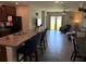 Open concept kitchen with a spacious island and seating, flowing into the adjacent living area at 9616 Lemon Drop Loop, Sun City Center, FL 33573