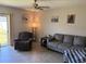 Living room area with a comfortable sofa, a recliner, and art pieces in a cozy living space at 9616 Lemon Drop Loop, Sun City Center, FL 33573