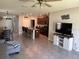 Open-concept living area showcasing a sleek entertainment center and flows into the modern kitchen at 9616 Lemon Drop Loop, Sun City Center, FL 33573