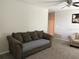 Open-concept living room with neutral carpet and plenty of natural light at 9616 Lemon Drop Loop, Sun City Center, FL 33573