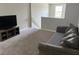 Cozy upstairs living room with neutral colored walls and carpeting at 9616 Lemon Drop Loop, Sun City Center, FL 33573
