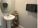 Pedestal sink in a well lit powder room at 9616 Lemon Drop Loop, Sun City Center, FL 33573