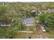Quaint home nestled among mature trees, offering privacy and charm from above at 10803 N Florence Ave, Tampa, FL 33612