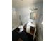 Bathroom with a shower, toilet, sink, and black tiled floors. Fixtures are dated at 10803 N Florence Ave, Tampa, FL 33612