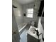 Updated bathroom featuring white tiled walls, modern fixtures, and new tile floors at 10803 N Florence Ave, Tampa, FL 33612