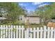 Cozy home with a welcoming white picket fence and stone pathway at 10803 N Florence Ave, Tampa, FL 33612