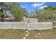 Charming home featuring a neat white picket fence and lush greenery at 10803 N Florence Ave, Tampa, FL 33612
