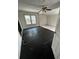 View into the living room featuring ceramic tiled floors, natural light, and a ceiling fan at 10803 N Florence Ave, Tampa, FL 33612