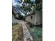 Exterior view showing a storage shed with brick pathway at 10803 N Florence Ave, Tampa, FL 33612