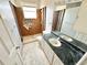 Bathroom features a vanity, toilet, and exposed plumbing, presenting a renovation opportunity at 1145 Riveredge Dr, Tarpon Springs, FL 34689
