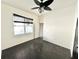 Bright bedroom features a ceiling fan, black window blinds, and neutral walls at 1145 Riveredge Dr, Tarpon Springs, FL 34689