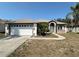 Charming single Gathering home with arched entryway and two-car garage at 1145 Riveredge Dr, Tarpon Springs, FL 34689