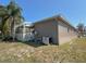 Home exterior features a screened-in porch and side yard space at 1145 Riveredge Dr, Tarpon Springs, FL 34689