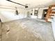 Spacious garage featuring a concrete floor, water heater, electrical panel, and plenty of storage space at 1145 Riveredge Dr, Tarpon Springs, FL 34689