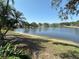 Scenic view of the lake with a sandy beach area at 1145 Riveredge Dr, Tarpon Springs, FL 34689