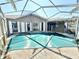 Pool and patio area with a covered pool and an attached screen, ready for outdoor relaxation at 1145 Riveredge Dr, Tarpon Springs, FL 34689