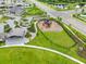 Aerial view of community playground, picnic pavilion and green space, with neighborhood in background at 11606 Kilkenny Coral Dr, Riverview, FL 33579