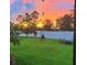 Green backyard with outdoor seating perfect for enjoying the evening sunset at 11606 Kilkenny Coral Dr, Riverview, FL 33579