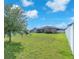 Expansive fenced backyard features a lush lawn, mature trees, and plenty of room for recreation at 11606 Kilkenny Coral Dr, Riverview, FL 33579