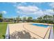 View of a community basketball court with black fence and playground in the background at 11606 Kilkenny Coral Dr, Riverview, FL 33579