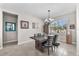Bright dining room features modern chandelier, decorative mirror, and access to the living areas at 11606 Kilkenny Coral Dr, Riverview, FL 33579