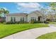 Well-maintained community center featuring lush landscaping and a sidewalk at 11606 Kilkenny Coral Dr, Riverview, FL 33579