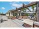 A covered outdoor kitchen with built-in grills and brick accents, perfect for entertaining guests at 11606 Kilkenny Coral Dr, Riverview, FL 33579