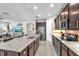 Modern kitchen featuring stainless steel appliances, granite countertops, and a large central island with breakfast bar at 11606 Kilkenny Coral Dr, Riverview, FL 33579