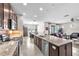 Open-concept kitchen with granite countertops, stainless steel appliances, and seamless flow into living and dining areas at 11606 Kilkenny Coral Dr, Riverview, FL 33579