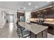 Gourmet kitchen features granite counters, stainless appliances, and a large island with seating for casual dining at 11606 Kilkenny Coral Dr, Riverview, FL 33579