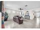 Spacious living room featuring tile flooring, neutral walls, and modern ceiling fan at 11606 Kilkenny Coral Dr, Riverview, FL 33579