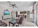Open-concept living room features a ceiling fan, tile floors, and a seamless flow into the modern kitchen at 11606 Kilkenny Coral Dr, Riverview, FL 33579