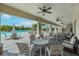 A luxurious patio with comfortable seating, ceiling fans, and views of the community pool at 11606 Kilkenny Coral Dr, Riverview, FL 33579