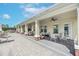 An outdoor patio area with tables, chairs, and ceiling fans for relaxing near the pool at 11606 Kilkenny Coral Dr, Riverview, FL 33579