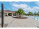 Beautiful community pool and shower area with palm trees for shade and plenty of seating at 11606 Kilkenny Coral Dr, Riverview, FL 33579