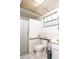 Bathroom with white tile, toilet and shower at 12303 Fieldstone Ln, Hudson, FL 34667