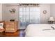 Bedroom with light walls, wood floors, and large windows at 12303 Fieldstone Ln, Hudson, FL 34667