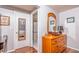 Bedroom hallway with hardwood floors, leading to the bed and bathroom at 12303 Fieldstone Ln, Hudson, FL 34667