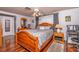 Comfortable bedroom featuring a wooden bed frame, hardwood floors, and ample natural light at 12303 Fieldstone Ln, Hudson, FL 34667