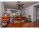 Charming dining room with hardwood floors, ceiling fan, and a large window offering natural light at 12303 Fieldstone Ln, Hudson, FL 34667