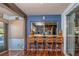 Kitchen bar with bright, orange wooden chairs and a connecting pass-through window to the kitchen at 12303 Fieldstone Ln, Hudson, FL 34667