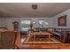 Inviting living room with hardwood floors, a leather sectional, and bright natural light at 12303 Fieldstone Ln, Hudson, FL 34667