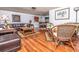 Spacious living room featuring hardwood floors, leather furniture, and elegant decor at 12303 Fieldstone Ln, Hudson, FL 34667
