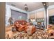 Comfortable living room featuring a leather sofa set and a patterned brown rug at 12303 Fieldstone Ln, Hudson, FL 34667