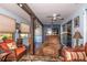 Open living space with wicker chairs, a brown leather sofa, and natural light throughout the room at 12303 Fieldstone Ln, Hudson, FL 34667