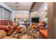 Cozy living room featuring a brown leather sofa set, natural light, and an entertainment center at 12303 Fieldstone Ln, Hudson, FL 34667