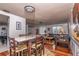 Open-concept living and dining area with hardwood floors and comfortable furnishings at 12303 Fieldstone Ln, Hudson, FL 34667